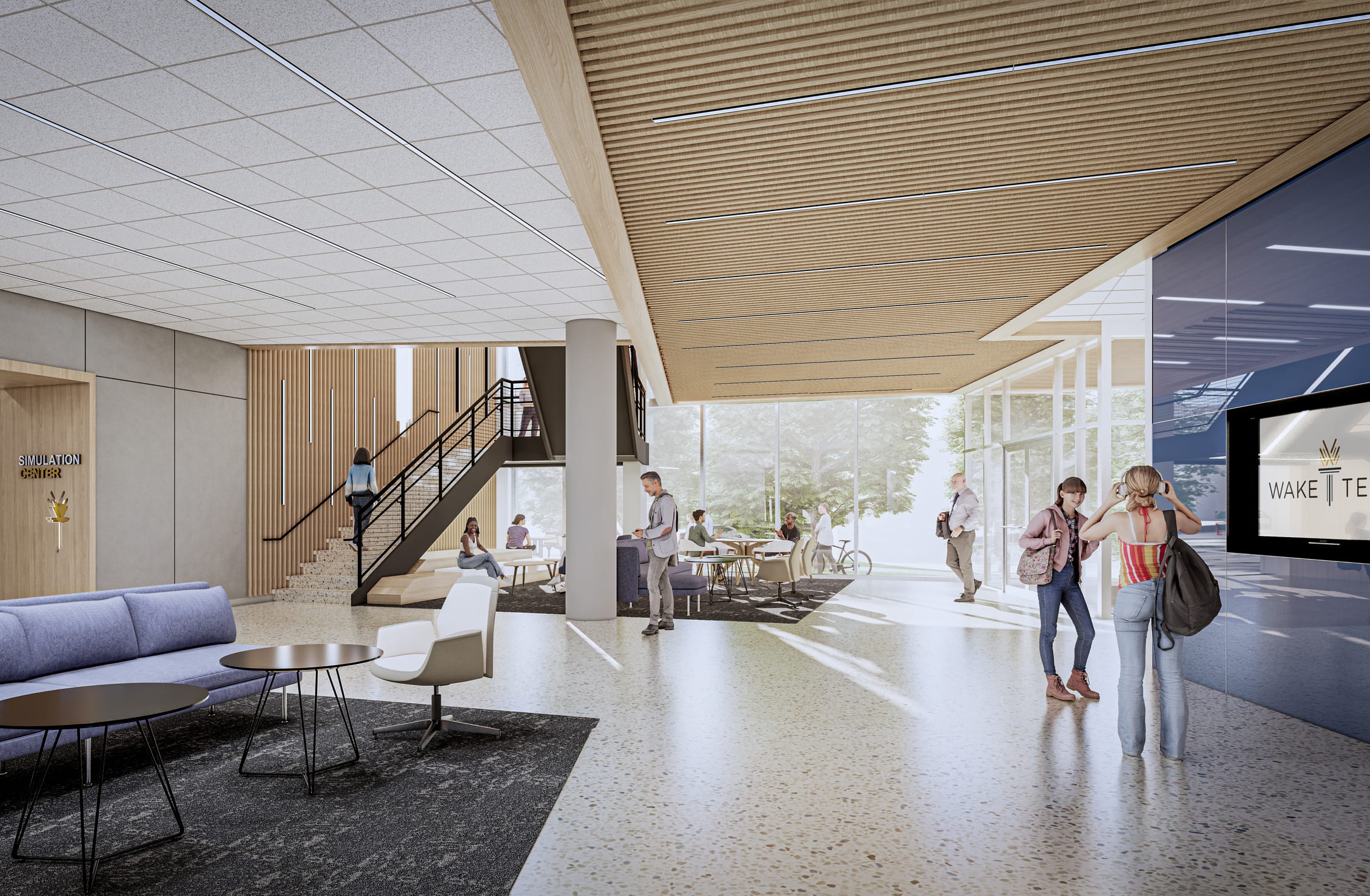 This rendering depicts a modern, light-filled interior space of the Wake Tech Health Sciences Building. The design features a blend of materials including wood slat ceilings, white acoustic tile, polished terrazzo flooring, and large glass windows that bring in natural light. The open layout includes a comfortable seating area with blue sofas and a round coffee table, a staircase with wooden accents, a